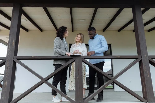 a couple having a conversation with a realtor
