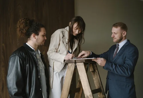 a couple signing papers with a realtor