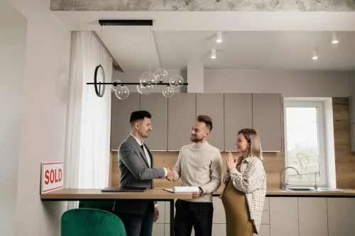 an image of a couple talking to a realtor